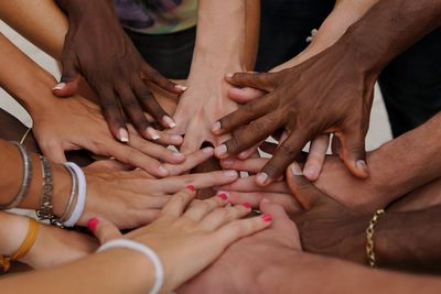 A number of hands in circle as symbol of support.