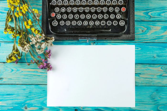 Image of a typewriter on a desk with writing paper