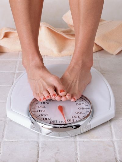 weight loss, set of weigh scales with bare feet.