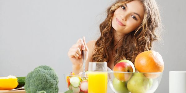 vegetables in front of woman for weight management
