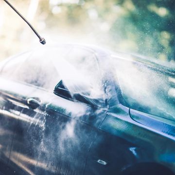 a sedan getting sprayed with mist from pressure washer