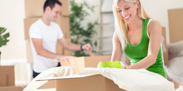 Refer Your Friends and Pick Your Neighbors - Couple Unpacking Boxes