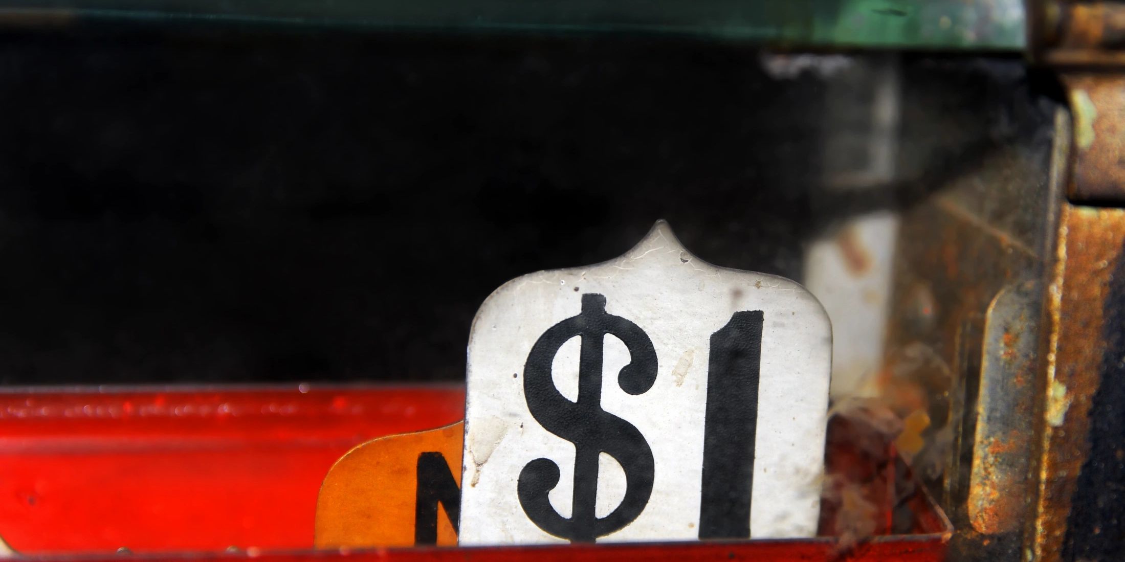 A vintage cash register $1 sign. 