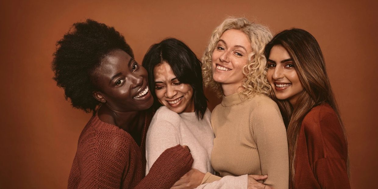 WOMEN OF ALL COLORS IN CIRCLE TOGETHER