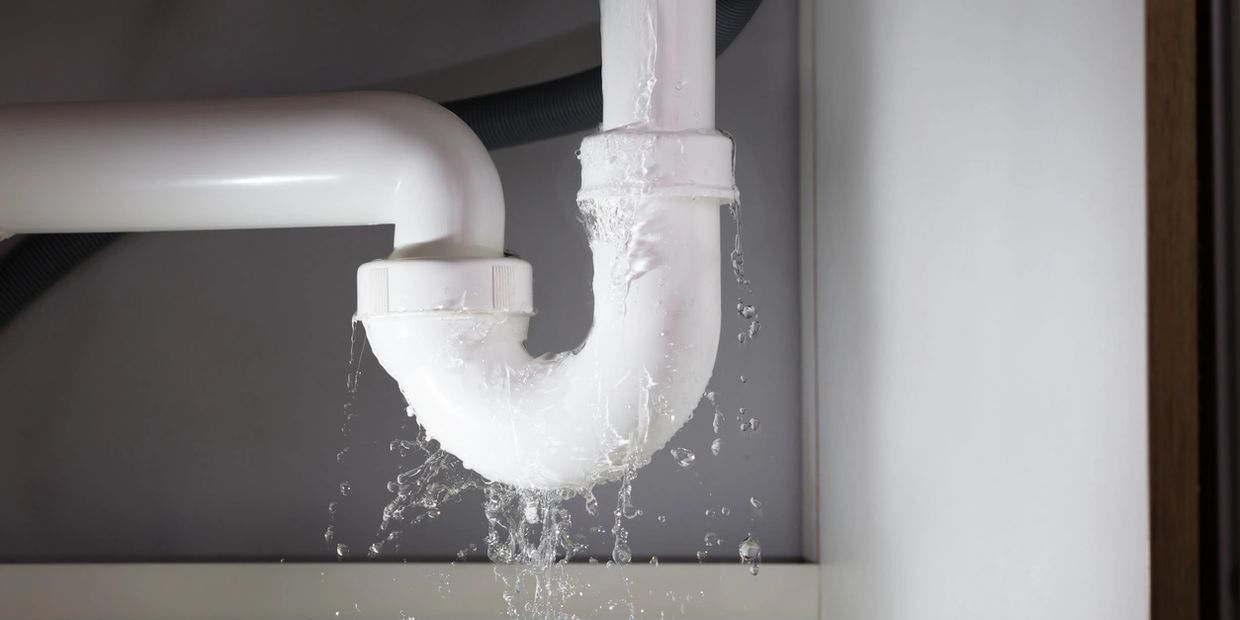 Water is leaking under a sink from the pipes which requires a rental property repair.