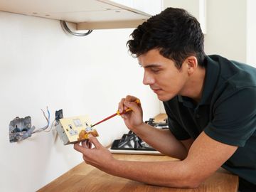 electrician fixing an outlet