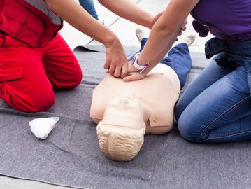 Instructor helping with CPR training.