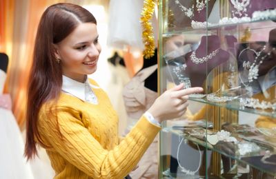 woman in yellow browsing through a jewelry store