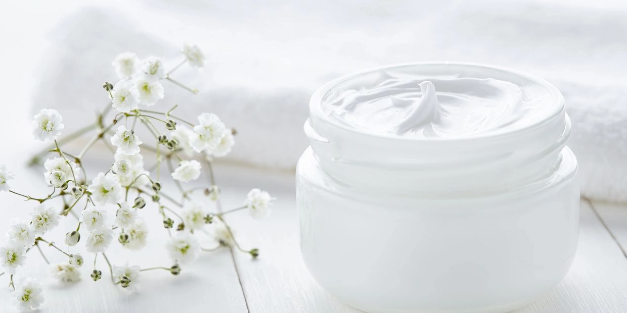 Luxury rich creamy body cream in a white jar.