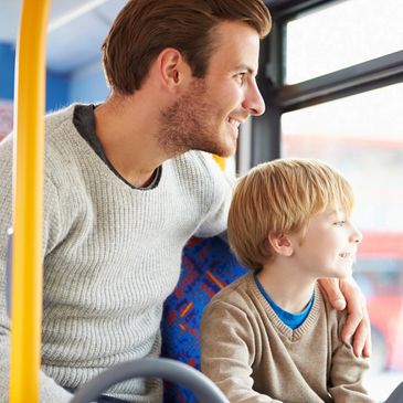 A father and a son in a bus. Family Chiropractic care keeps families moving. 