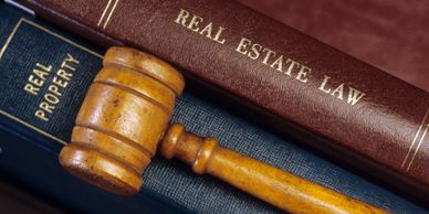 books on real estate and a gavel