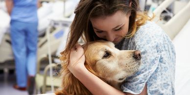 A picture of a woman hugging a golden retriever