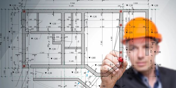 architect with hard hat providing field revisions