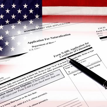 A pen and federal forms with an American flag in the background