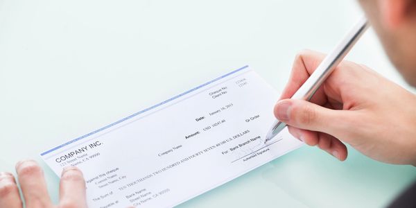 a person signing a check