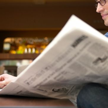 image of individual reading paper newspaper 
