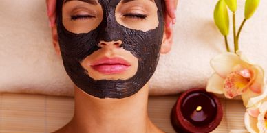 Woman with eyes closed relaxing with face mask applied