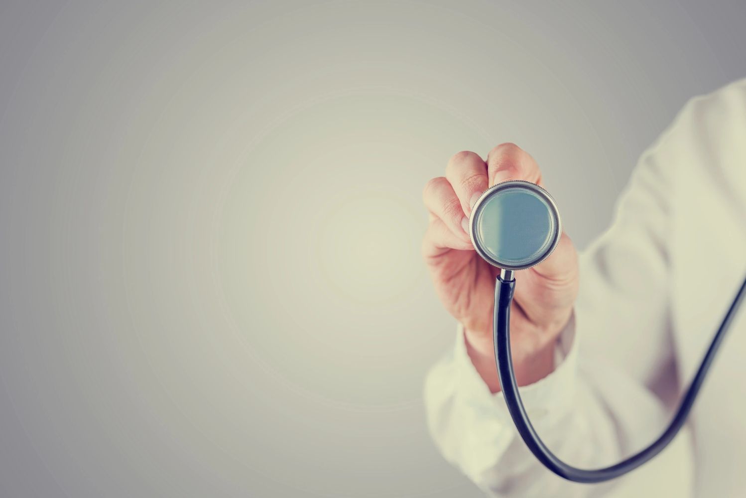 stock image of a person holding up a stethoscope