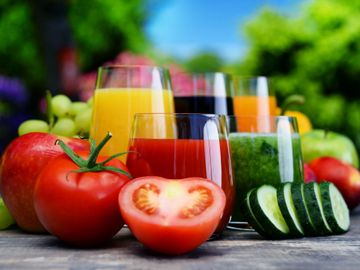 Glasses of juice and images of fruits and vegetables, such as grapes, apples, and tomatoes.