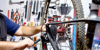 A bicycle mechanic works on a mountain bike 
