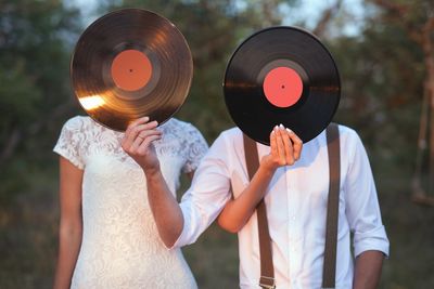 two people with vinyl records