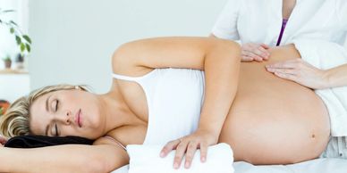 Prenatal Massage, woman is lying on her side with towel.