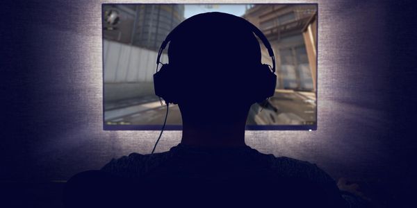 Person gaming with a gaming headset