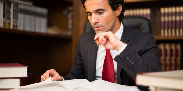 Licensed lawyer studying legal wills and powers of attorney