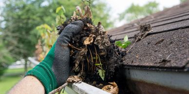Cleaning unwanted debris and muck in your gutters.