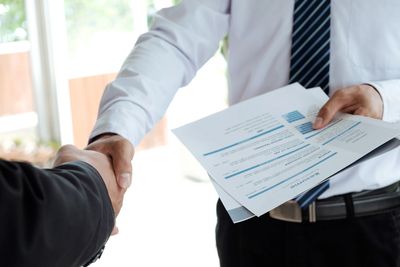 Man passing in a resume and shaking hands