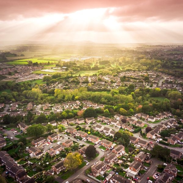 Aerial photo of a village showing sun through clouds