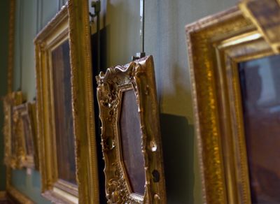 Gold picture frames on a gallery wall
