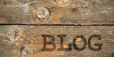 Dry wood, stained a light brown with the word BLOG in capital letters.