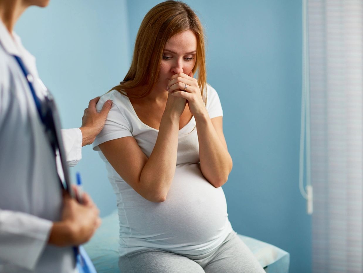 Pregnant girl looking worried about how she will get financial help with her pregnancy