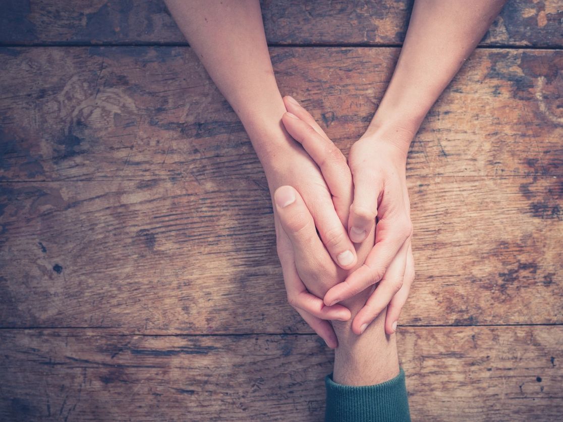 Hands holding a hand. To show we are here for you.