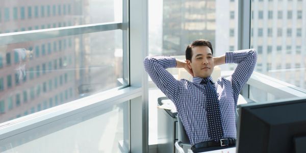 Business person relaxing at his desk