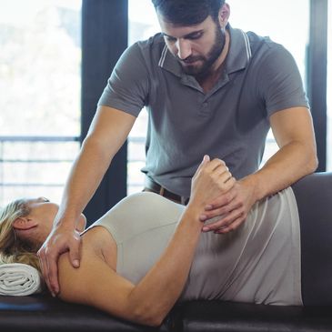 Physical therapist stretching a client