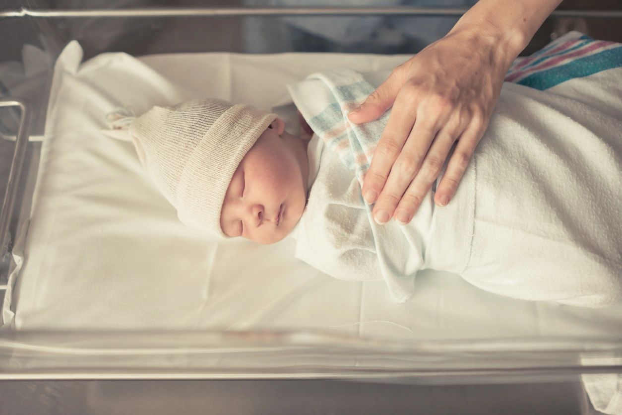 Newborn baby with nurse