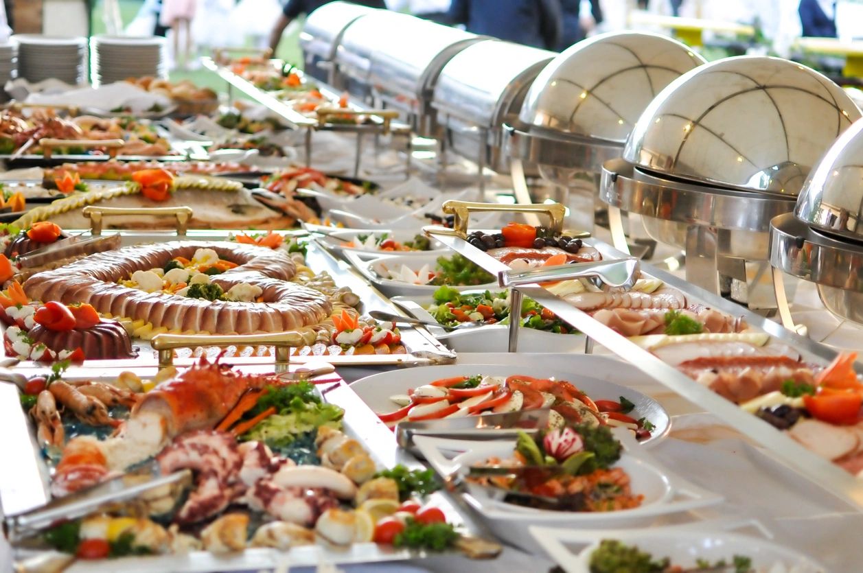A table for food buffet filled with various dishes