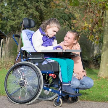 Girl in wheelchair with volunteer respite program