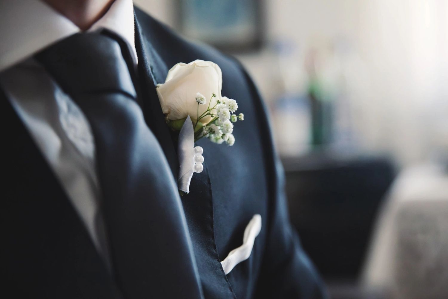 Groom wearing navy hire suit with matching tie, buttonhole & pocket square