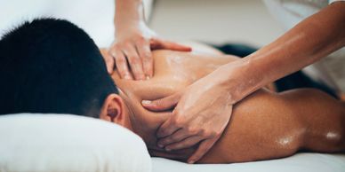Man receiving therapeutic massage and myofascial bodywork.