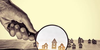 Magnifying glass over houses