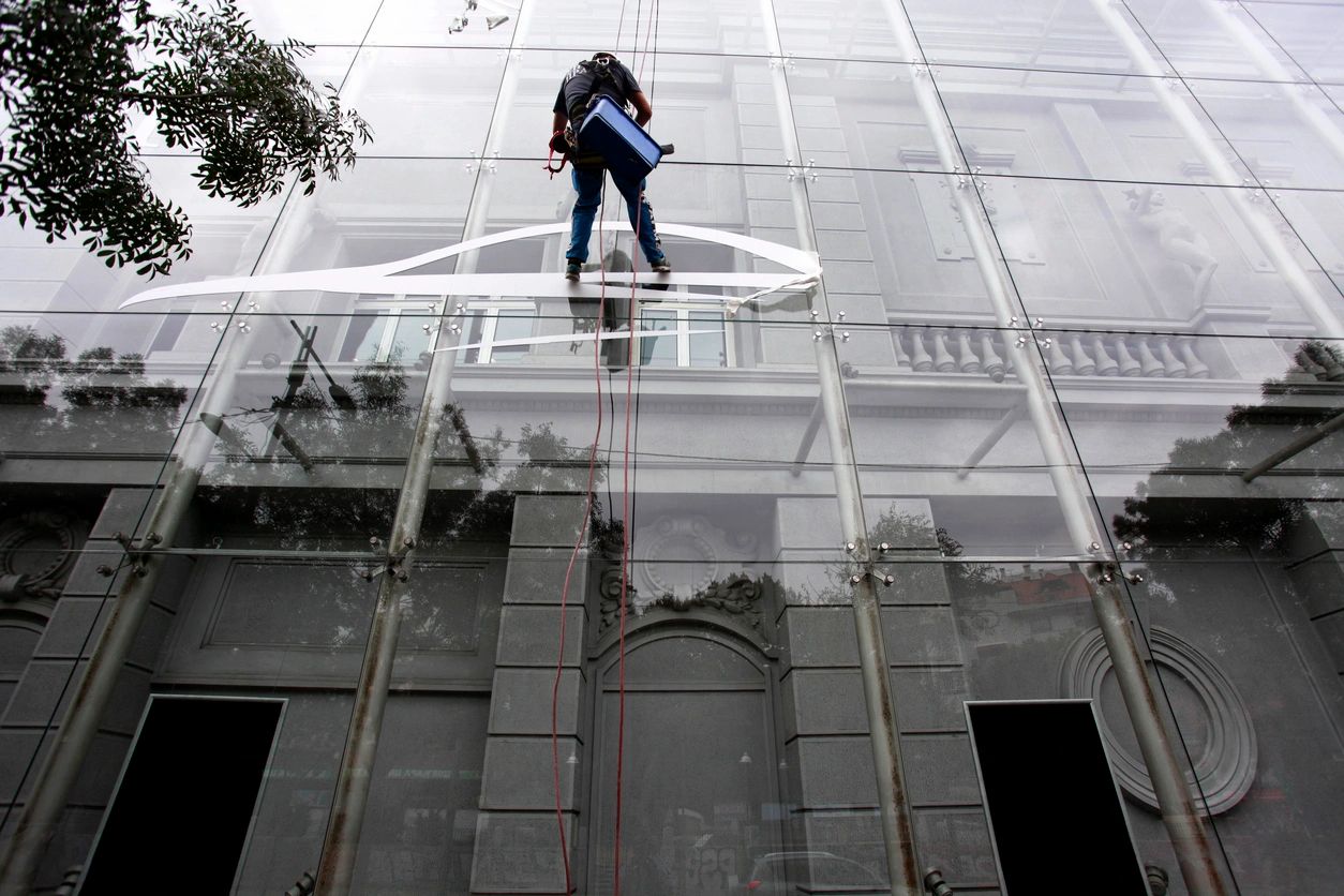 Window cleaner working on a row of windows