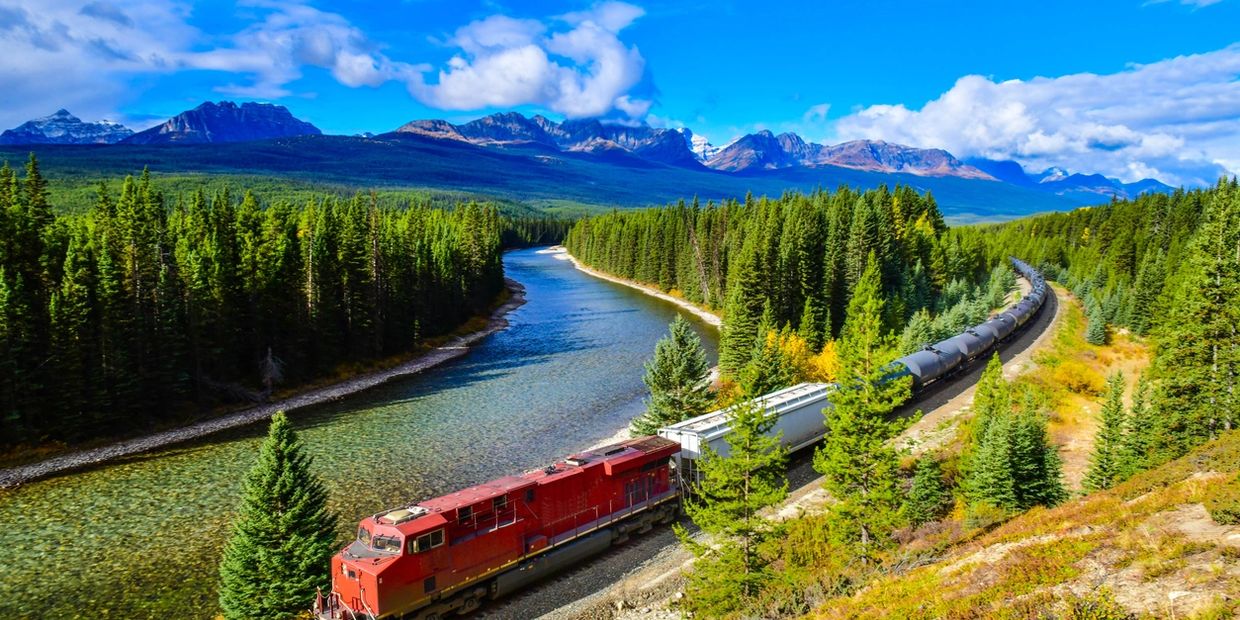 Alberta Scenery showing an industrial train travelling through the Rocky Mountain 