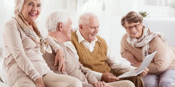 Four elders wearing brown clothing
