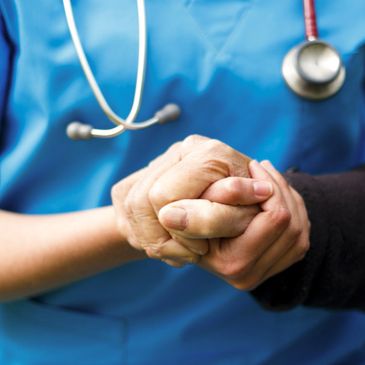 nurse and senior holding hands
