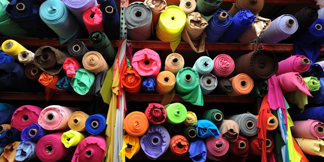 colorful rolls of fabric for a sewing studio or at room