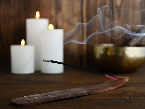 Relaxing scent of incense burning with Tibetan singing bowls and candles.