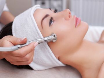 Client receiving microdermabrasion treatment